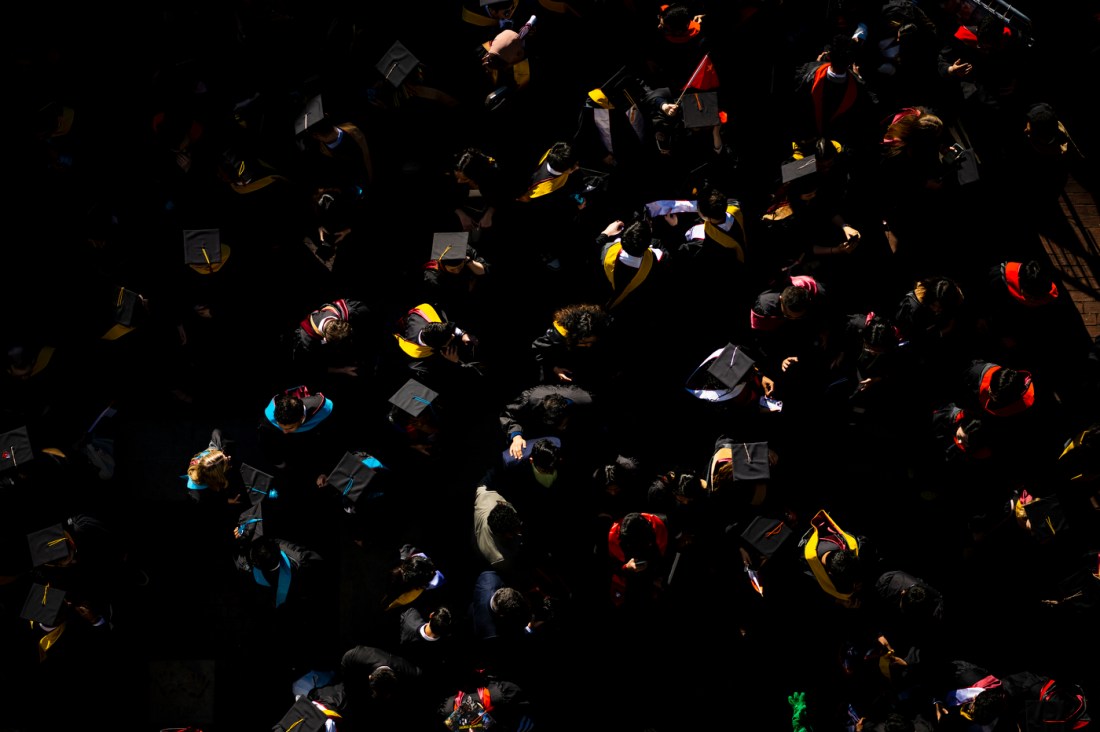 Northeastern students wearing caps and gowns seen from overhead.
