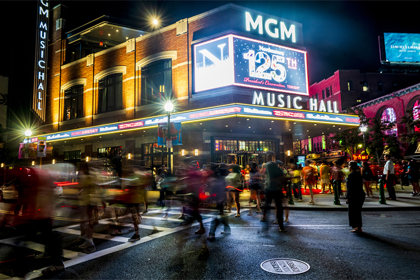 Exterior of MGM Music Hall at night lit up for Northeastern's 125 Convocation.