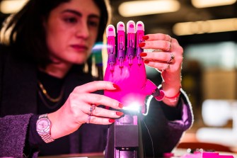 Third-year bioengineering student Isabela Castillo works on a 3D-printed prosthetic hand in EXP’s makerspace on Northeastern’s Boston campus.