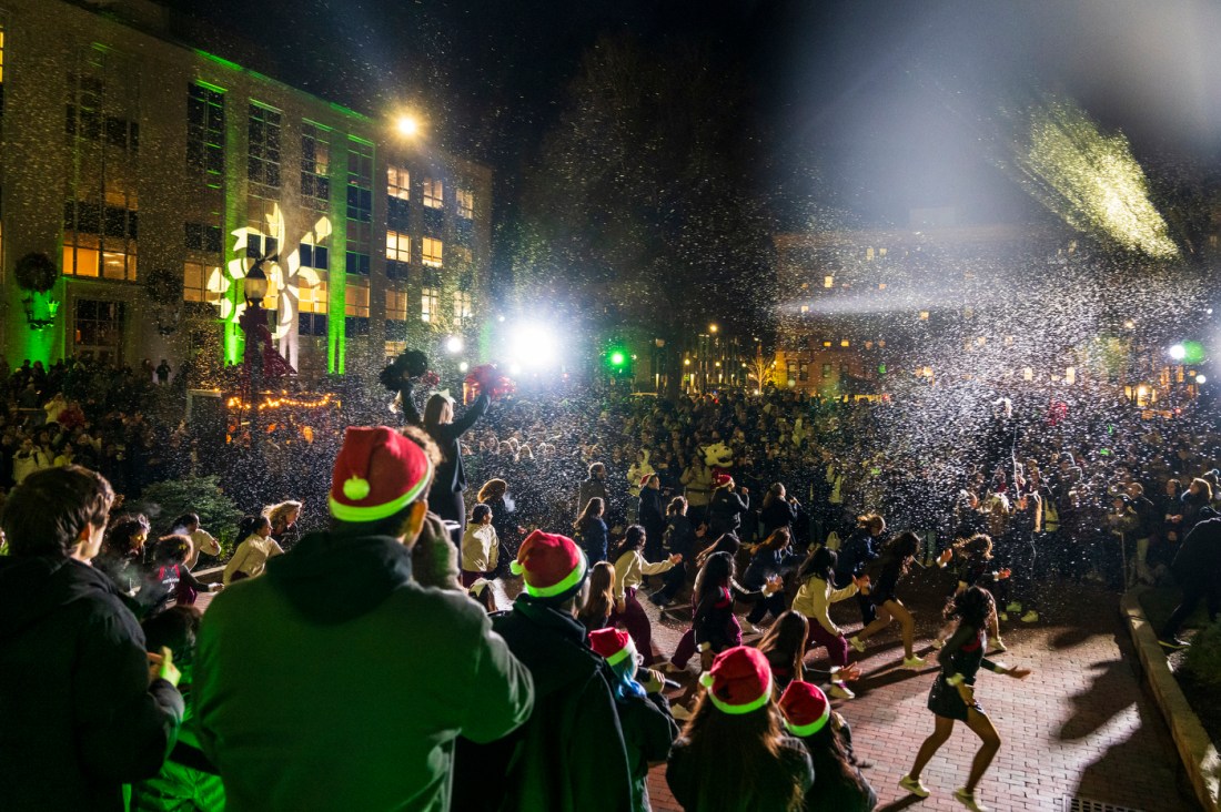 A large crowd cheers during Northeastern's Joy and Light Holiday Showcase. 