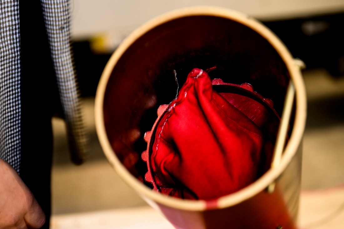 An engineering project involving red cloth in a cylindrical tube.