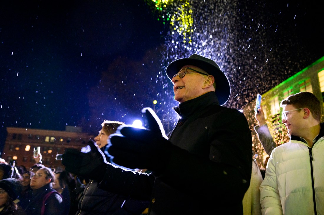 President Joseph E. Aoun celebrates outside at Northeastern's Joy and Light Holiday Showcase.
