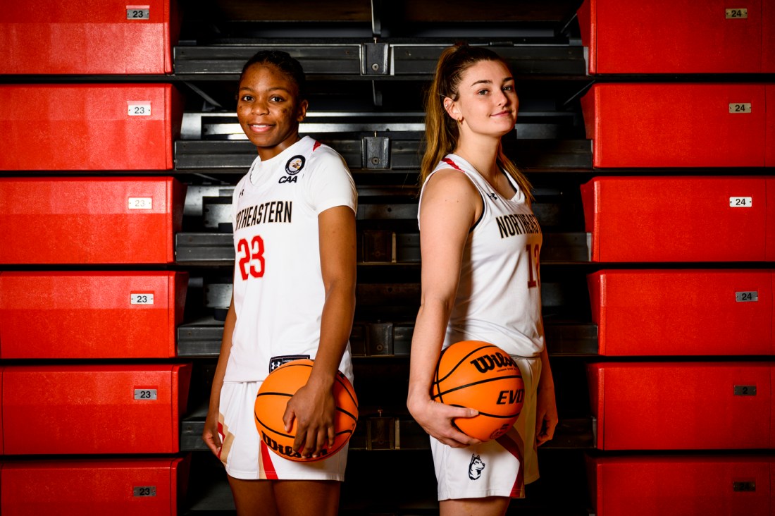Gemima Motema and Camille Clement posing with basketballs back to back. 