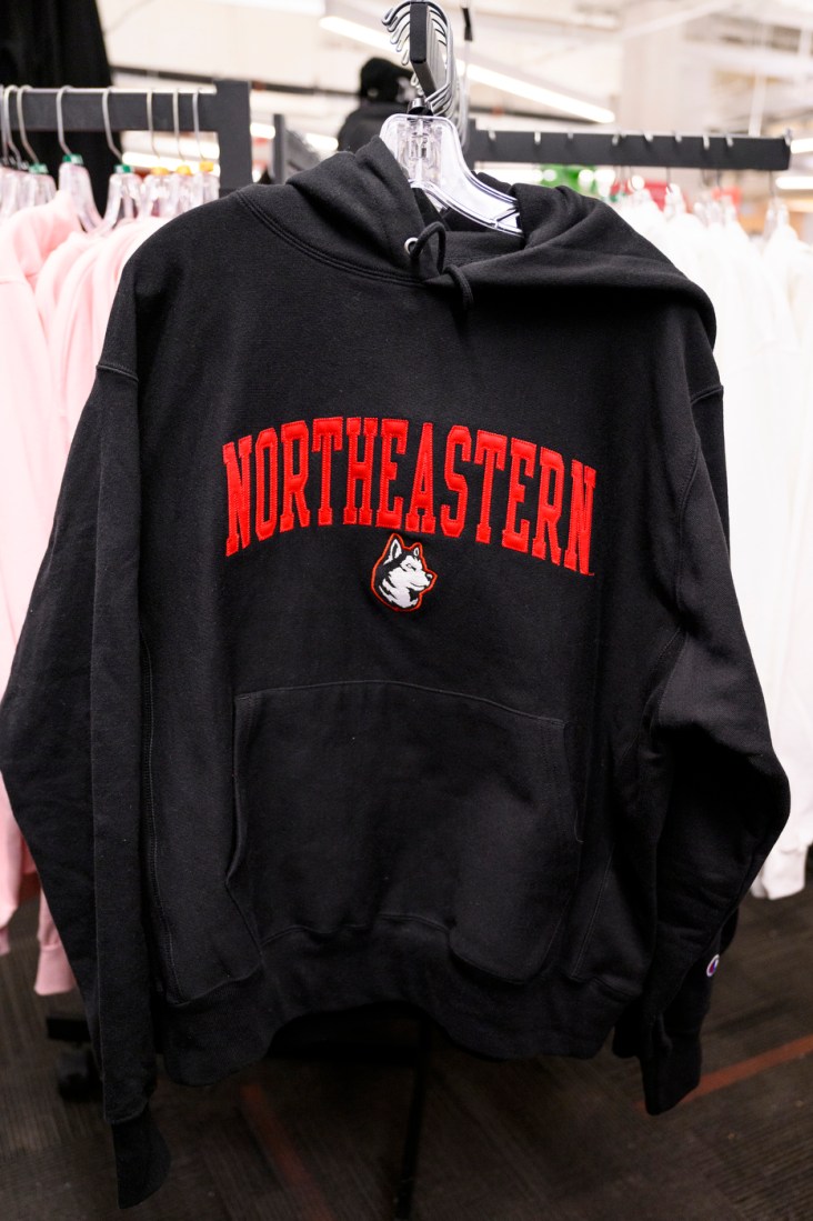 A black sweatshirt with Northeastern written in red and the husky.