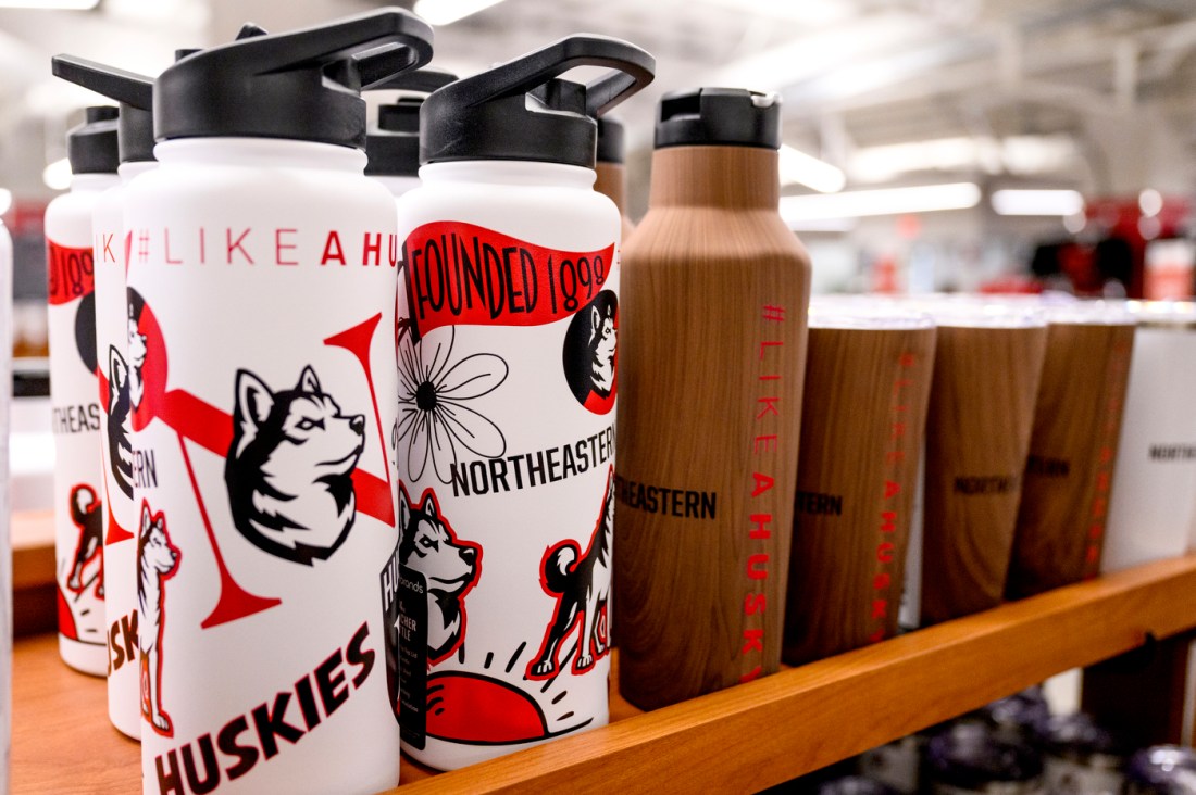 Several Northeastern branded water bottles and travel mugs.