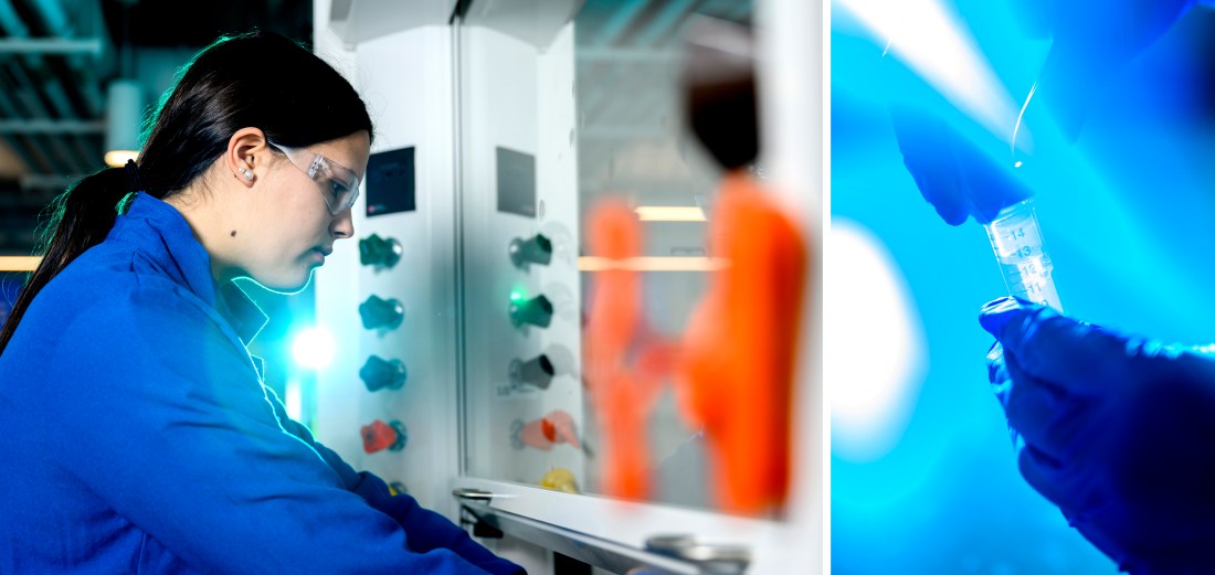 A person wearing a blue lab coat works inside a laboratory. 