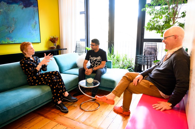 Amy and Ethan Dabelmont Burnes speaking with Harsh Shah in their living room. 