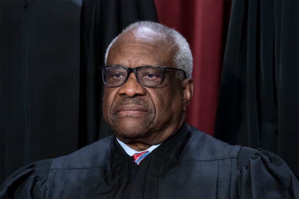 Clarence Thomas posing for a portrait at the Supreme Court building.