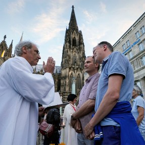 Same sex couple receiving a blessing by a priest in Germany.