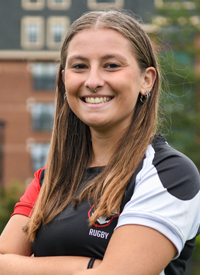 Headshot of Cara Stanizzi outside in their Rugby uniform.