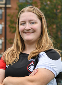 Headshot of Grace Preston outside in their Rugby uniform.