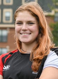 Headshot of Molly McAlevey outside in their Rugby uniform.