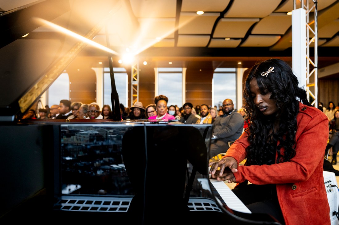 Event attendees at Northeastern's MLK watch a pianist play.