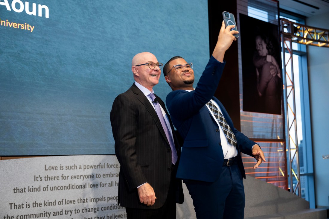 Gregory Hollis and President Aoun take a selfie on the stage of the event.