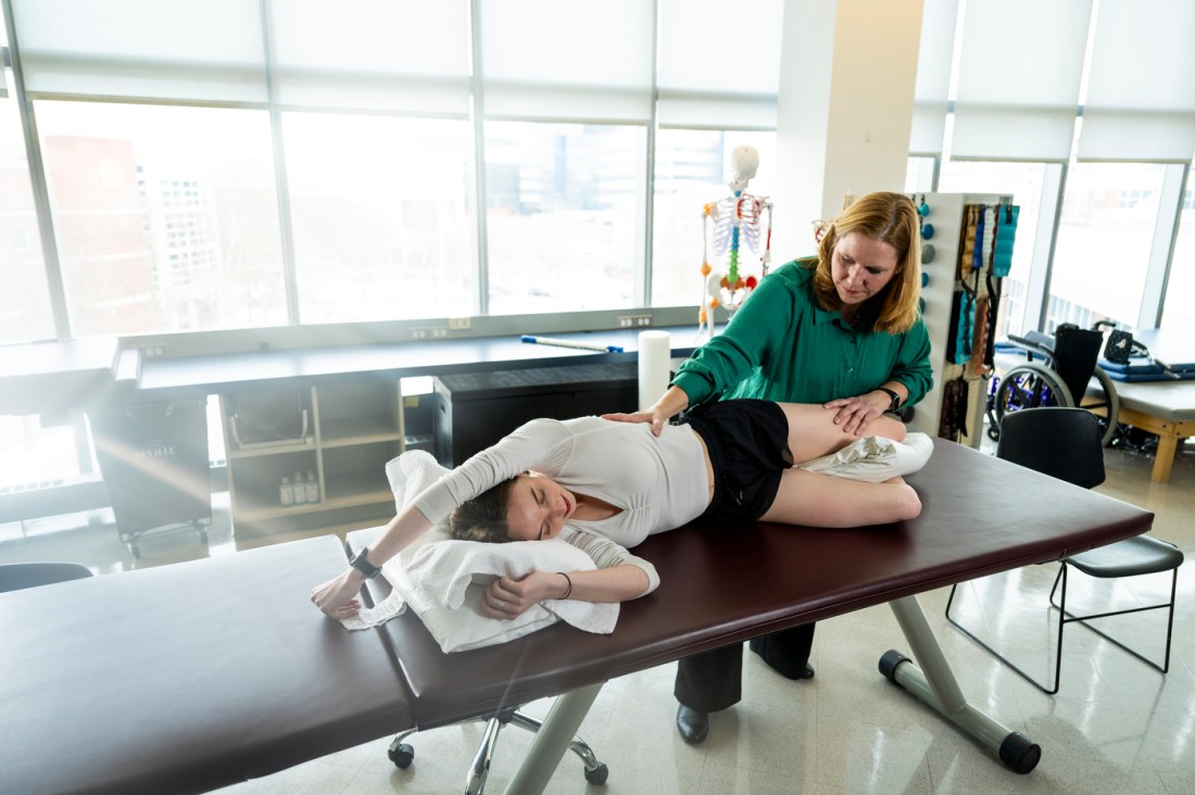 Dr. Maureen Watkins helping a student with fascia release.