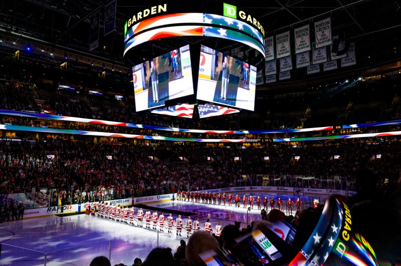 Northeastern women's hockey team and BU women's hockey team lined up on the ice at TD GArden for the National Anthem.