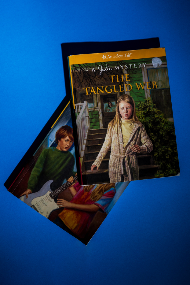 A stack of two books, one titled 'The Tangled Web: A Julie Mystery' on top.