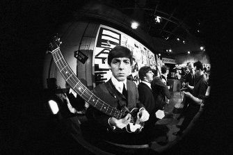 Black and white fish eye photo of the Beatles.