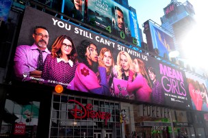 A billboard displaying an advertisement for the "Mean Girls" film.