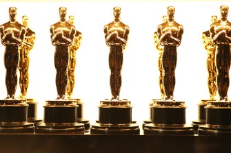 Oscar award statuettes lined up backstage.
