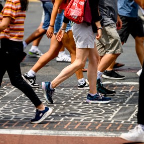 A crowd of pedestrians crossing a street.