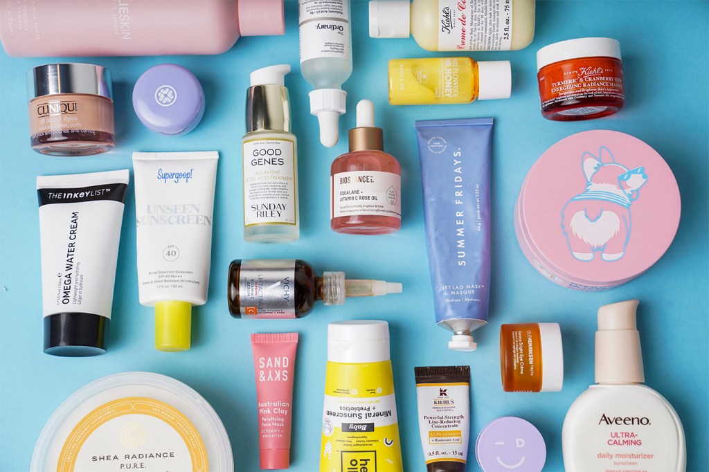 Various multi-colored anti-aging skin care products are placed on a blue background.