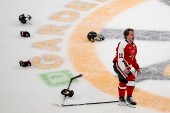 Gunnarwolfe Fontaine celebrates Northeastern's victory over Boston University on the ice at TD Garden.