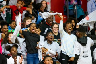 Boston Public Schools students cheering on a basketball game.