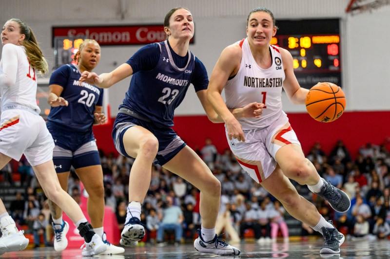 Northeastern basketball player dribbling with the ball.