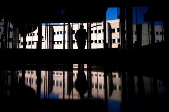 A person walks inside of Northeastern's Interdisciplinary Science and Engineering Complex.