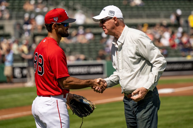 Paul Gavin shaking the hand of a Red Sox player.