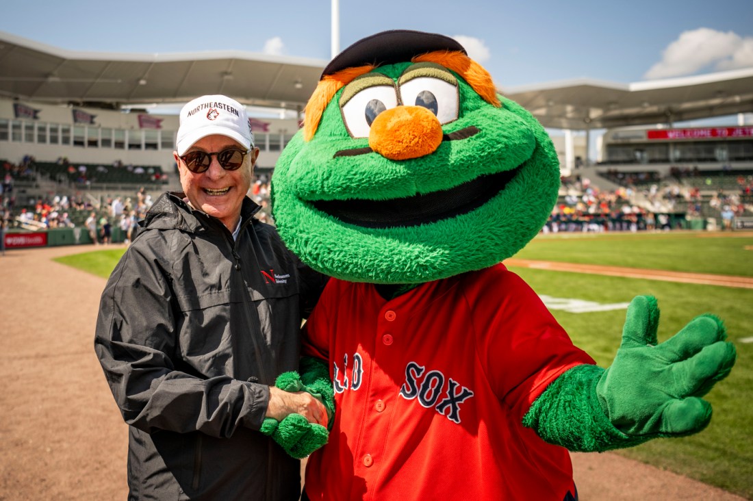 President Joseph E. Aoun poses for a picture with Boston Red Sox's mascot, Wally the Green Monster.