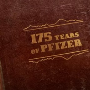 A brown book with golden-colored text: "175 years of Pfizer."