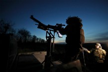 A serviceman on combat duty at dusk.