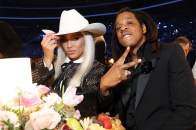 Beyonce, wearing a white 10-gallon hat, and Jay-Z, wearing a black suit, attend the 66th GRAMMY Awards.