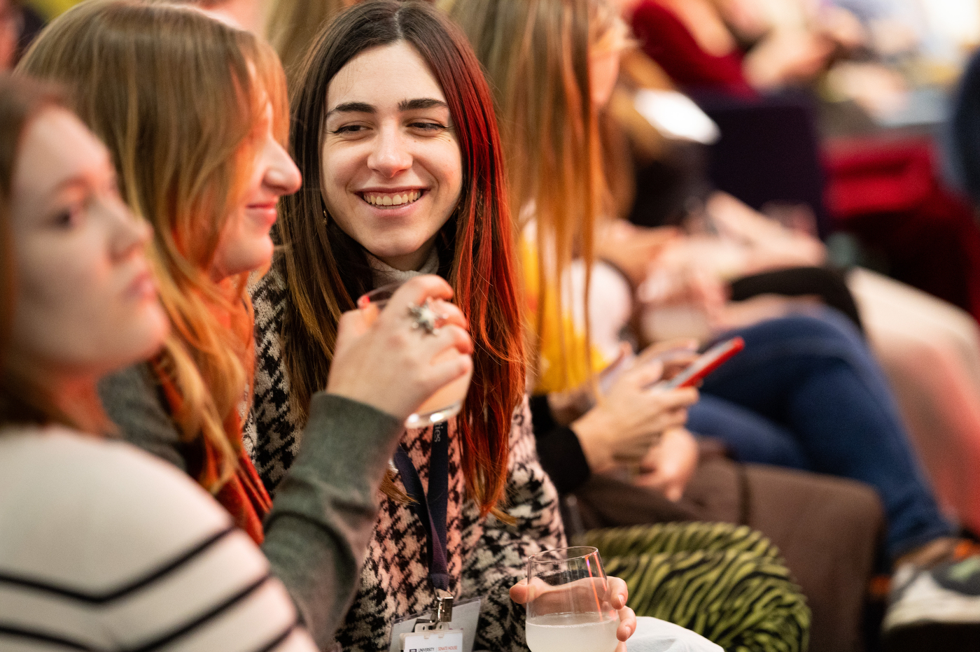 Attendees smiling at each other at a Women Who Empower event in London.