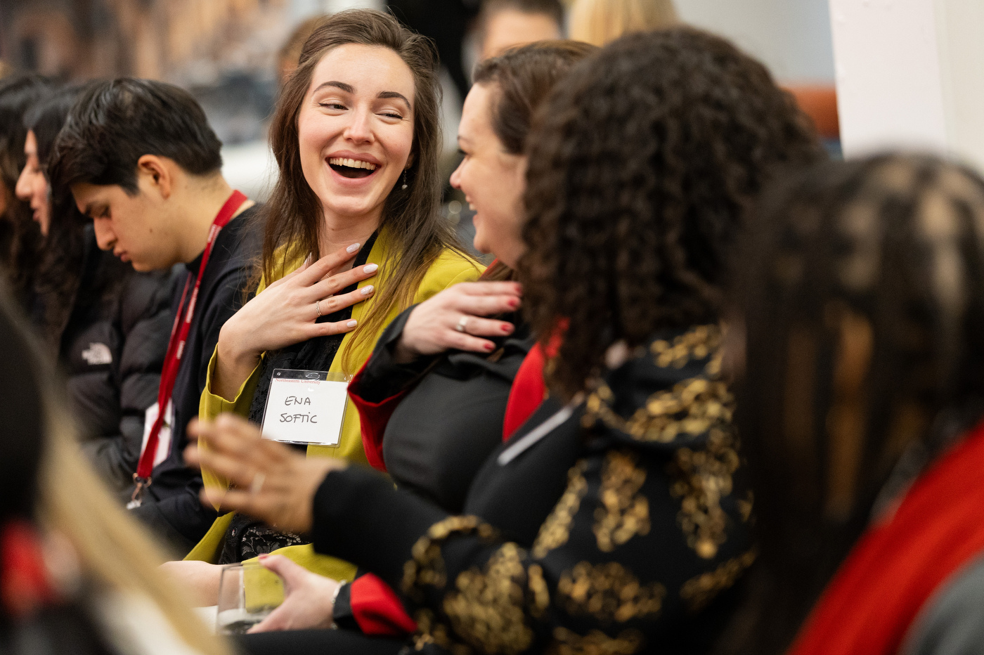 Attendees at Women Who Empower event laughing with each other.