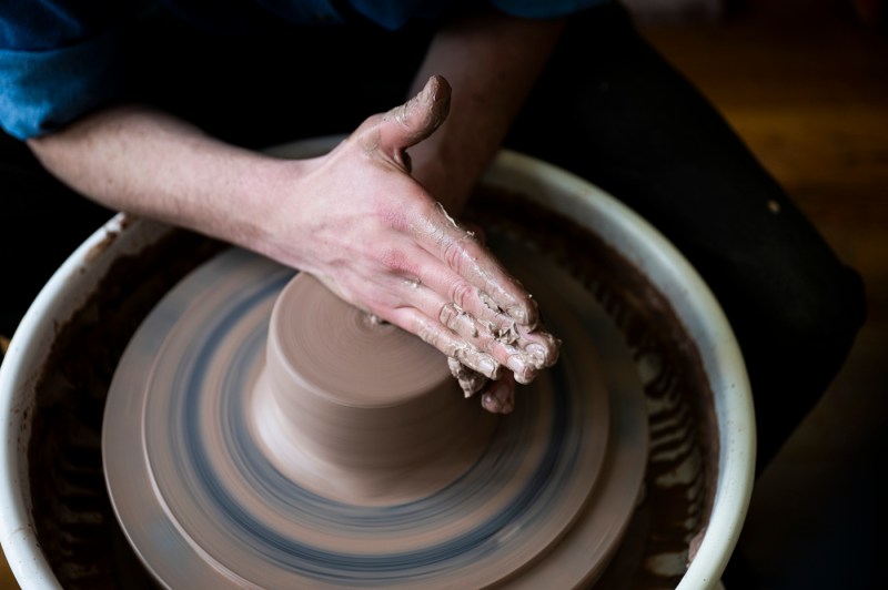 David Chatson throwing pottery on a wheel.