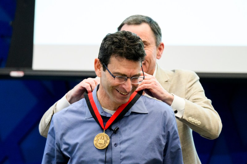 David Madigan placing a medal around Ronald Sandler's neck at Klein Lecture.