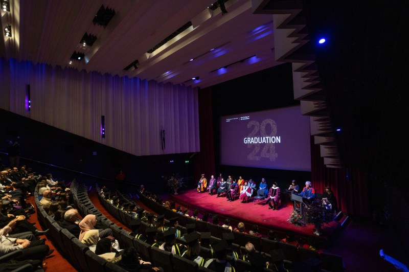 Auditorium full of people at Northeastern University London 2024 graduation.