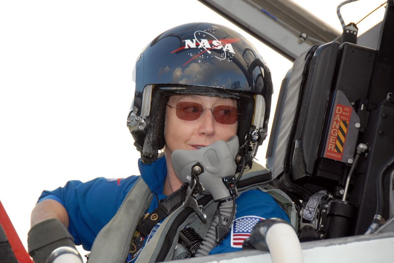 Pam Melroy wearing a NASA helmet.