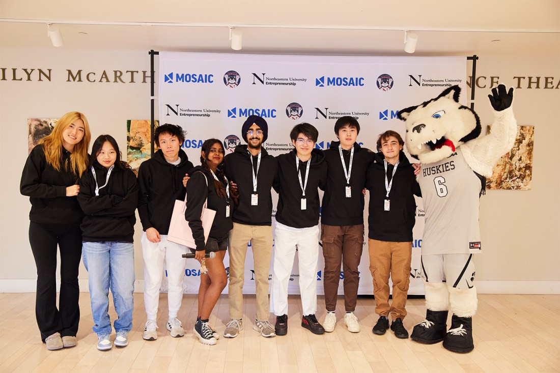 A group of students posing with Paws at the Hackathon.