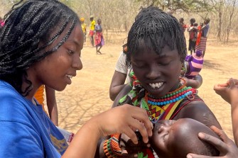 Leah Orkuo with a child in Kenya.
