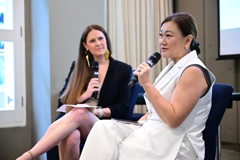 Two people speaking at the Global Leadership Summit in Singapore. 
