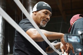 Mike Tyson against the ropes of a boxing ring
