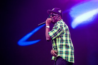 Rapper Lil Yachty performing in a green plaid shirt.