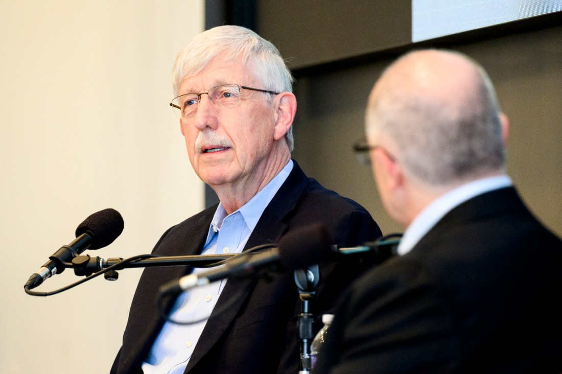 Dave DeSteno and Francis Collins speaking into microphones. 