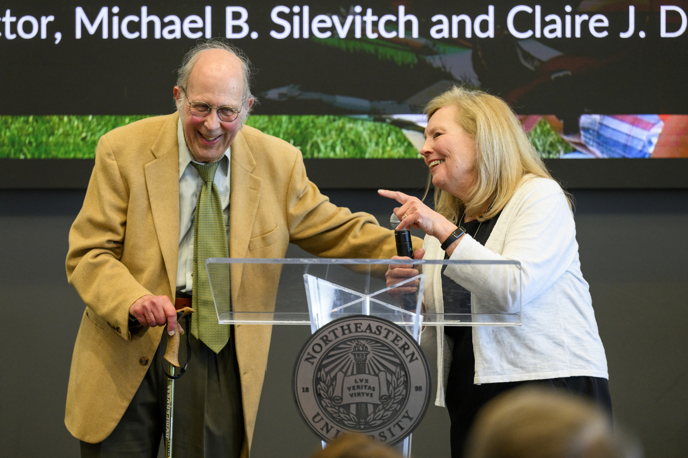 Michael B. Silevitch and Claire J. Duggan at a podium at the rededication.