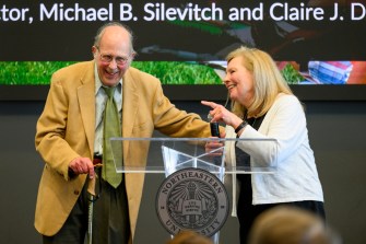 Michael B. Silevitch and Claire J. Duggan at a podium at the rededication.
