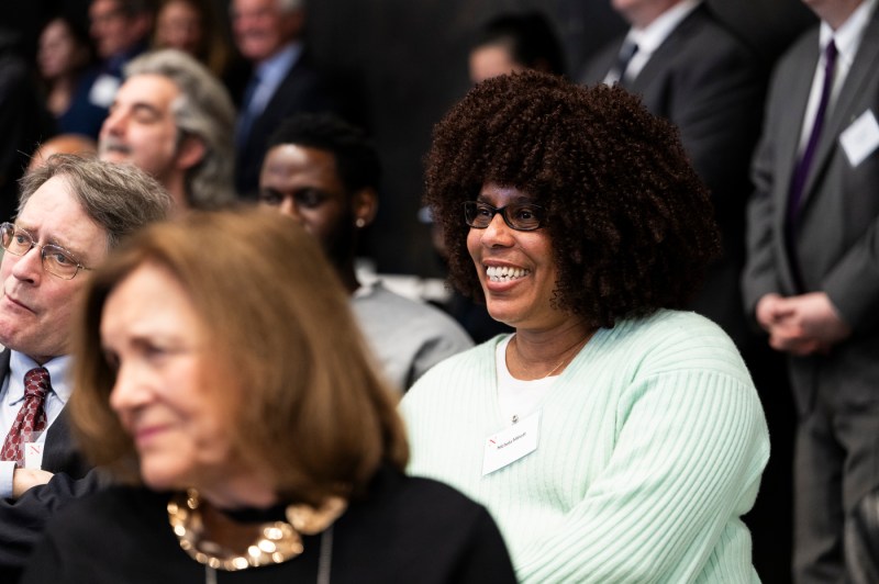 An audience member smiles at the Dukakis celebration.